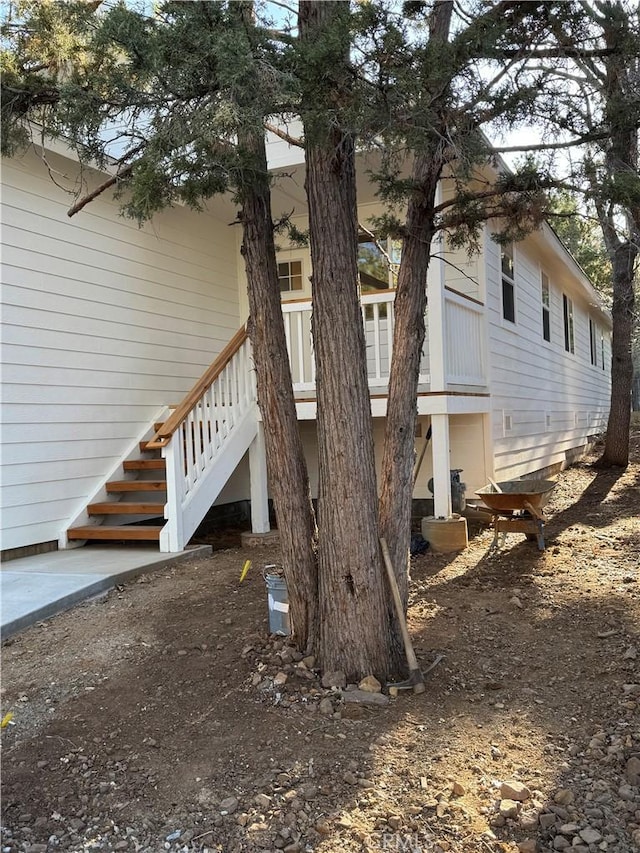 view of side of property featuring stairway