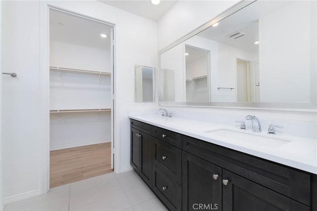 4021 E Perdido Privado, Ontario, CA 91761 - full bath with visible vents, a sink, a walk in closet, and tile patterned flooring
