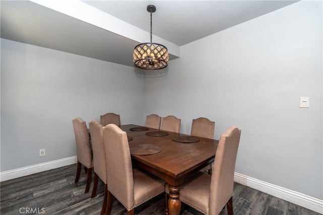 dining room featuring baseboards, a notable chandelier, and dark wood-type flooring