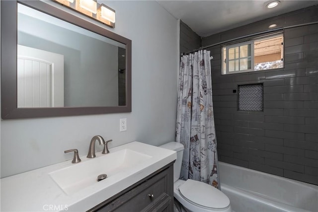 bathroom featuring vanity, shower / bathtub combination with curtain, and toilet