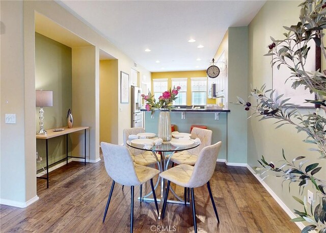 dining area with recessed lighting, baseboards, and wood finished floors