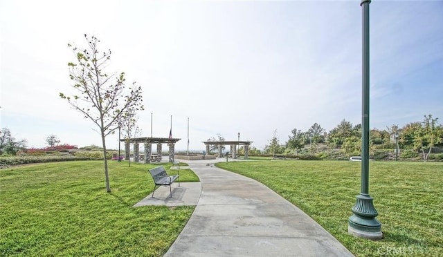 view of home's community with a yard