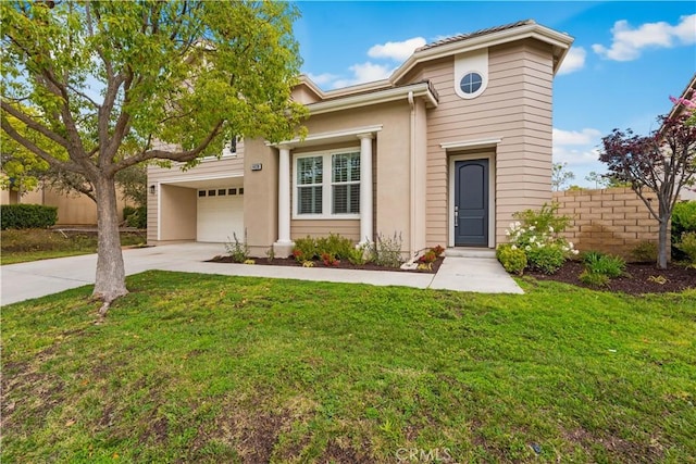 view of front of home featuring concrete driveway and stucco siding