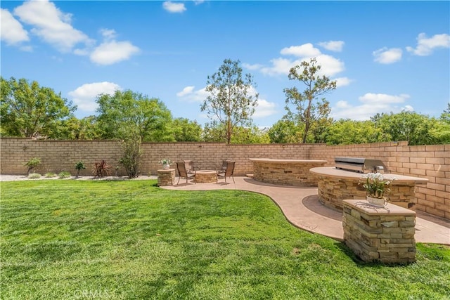 view of yard with a fire pit and a patio area