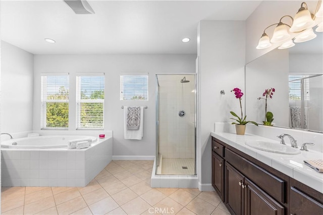 full bathroom with healthy amount of natural light, a stall shower, vanity, and recessed lighting