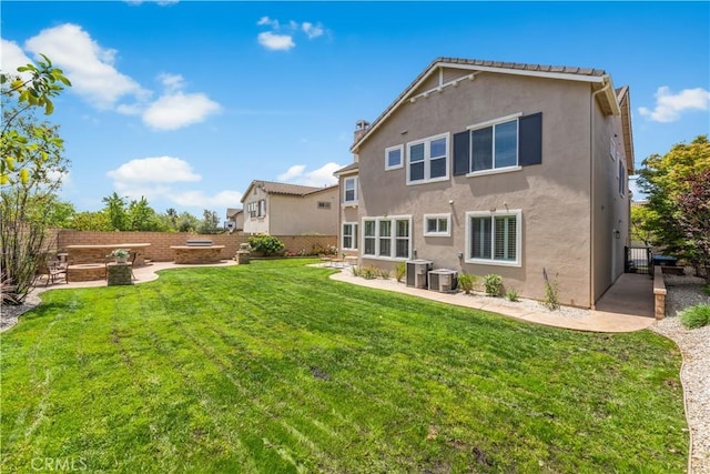 back of house featuring a patio, stucco siding, cooling unit, and a fire pit