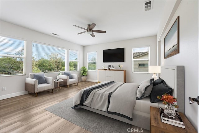 bedroom featuring wood finished floors, baseboards, and ceiling fan