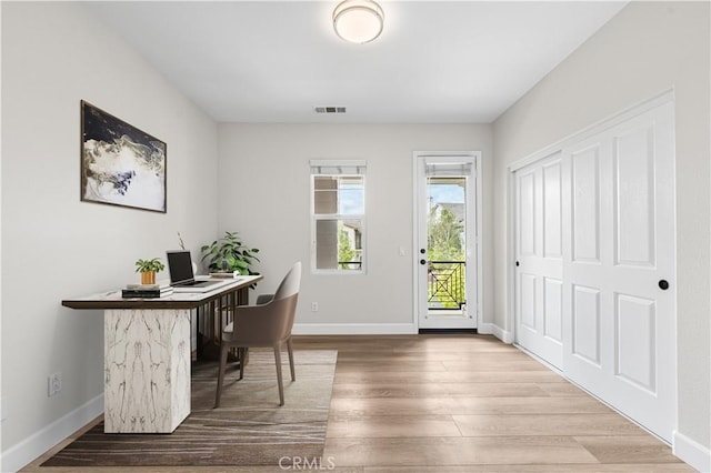 office area with wood finished floors and baseboards