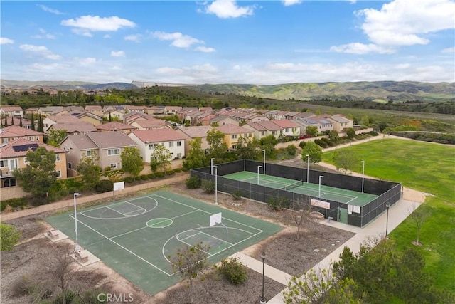 view of sport court with a residential view, community basketball court, and a mountain view