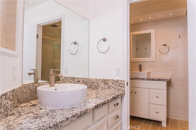 bathroom with recessed lighting, tile patterned flooring, and vanity