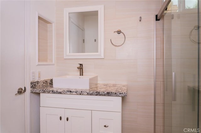 bathroom featuring a shower stall and vanity