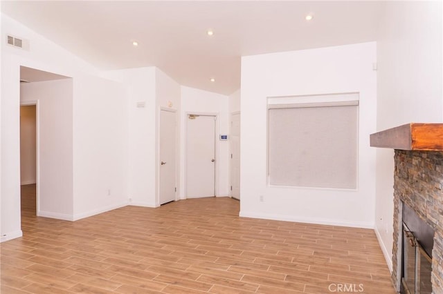 unfurnished living room with visible vents, a fireplace, baseboards, light wood-style floors, and recessed lighting