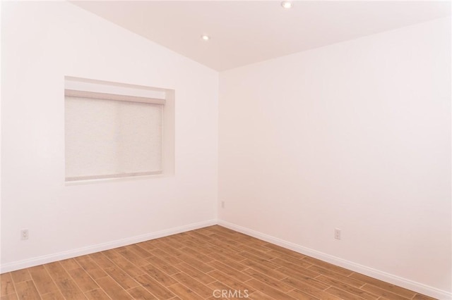 unfurnished room with recessed lighting, baseboards, and light wood-style floors