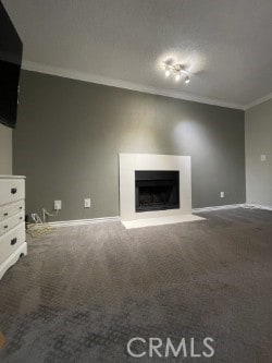 unfurnished living room with ornamental molding, dark carpet, and a fireplace