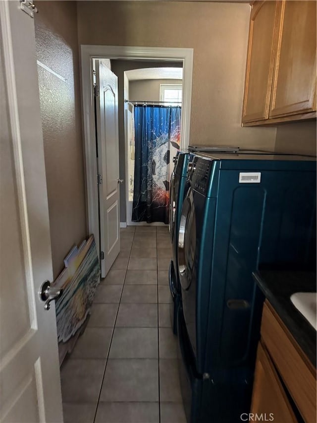 17815 Chestnut St, Hesperia, CA 92345 - laundry area with washer and clothes dryer, light tile patterned floors, and cabinet space