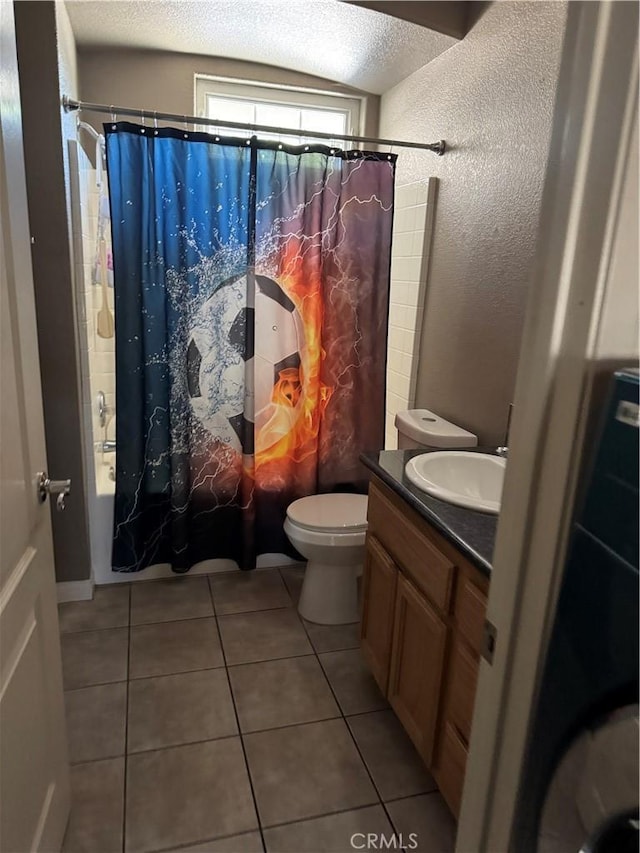 17815 Chestnut St, Hesperia, CA 92345 - bathroom with shower / bathtub combination with curtain, toilet, tile patterned flooring, a textured wall, and vanity