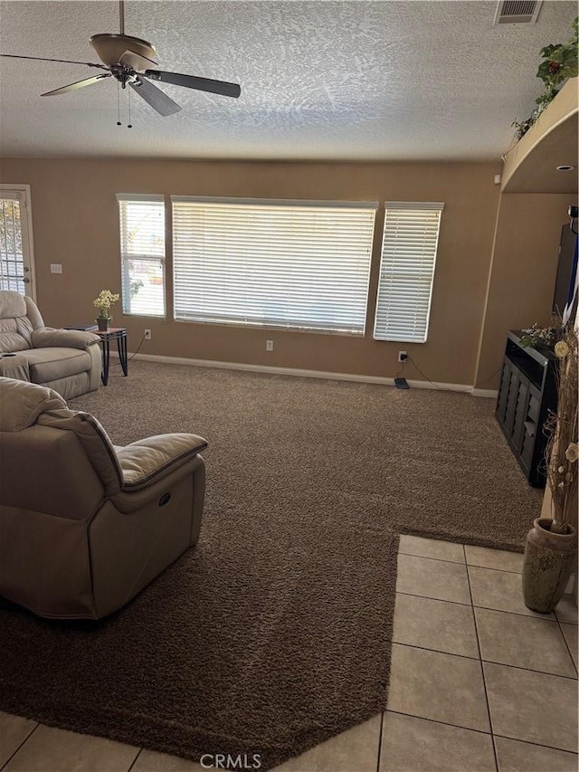 17815 Chestnut St, Hesperia, CA 92345 - carpeted living room featuring a ceiling fan, healthy amount of natural light, baseboards, and a textured ceiling