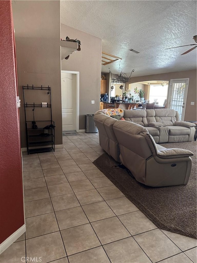 17815 Chestnut St, Hesperia, CA 92345 - living room with a textured ceiling, light tile patterned flooring, and a ceiling fan