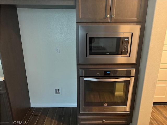 room details with dark wood-style flooring, baseboards, and appliances with stainless steel finishes