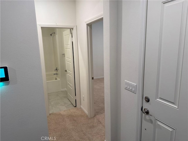corridor featuring light colored carpet