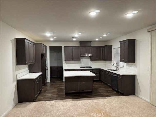 kitchen featuring dark brown cabinetry, a kitchen island, baseboards, a sink, and black appliances