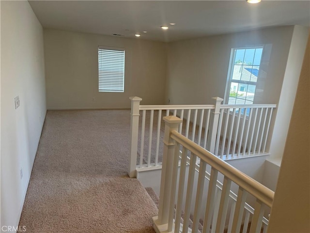 corridor with recessed lighting, an upstairs landing, and carpet