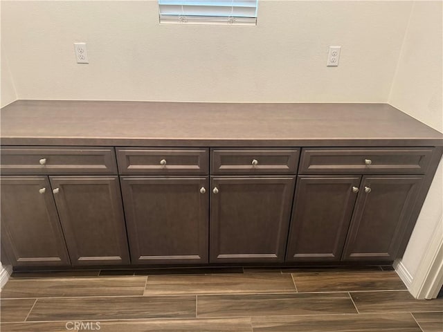 room details featuring baseboards and wood finished floors