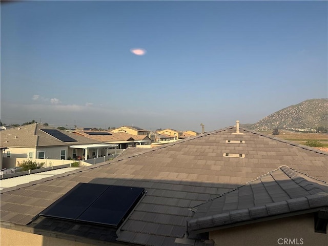 exterior space with a mountain view and a residential view