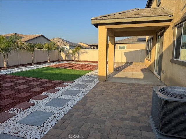 view of patio with a fenced backyard and central AC unit
