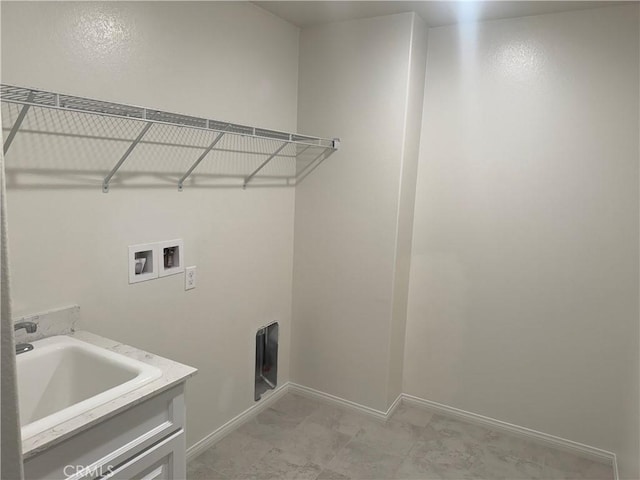 washroom featuring laundry area, a sink, baseboards, and hookup for a washing machine