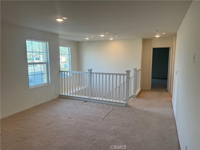 carpeted empty room with recessed lighting and baseboards