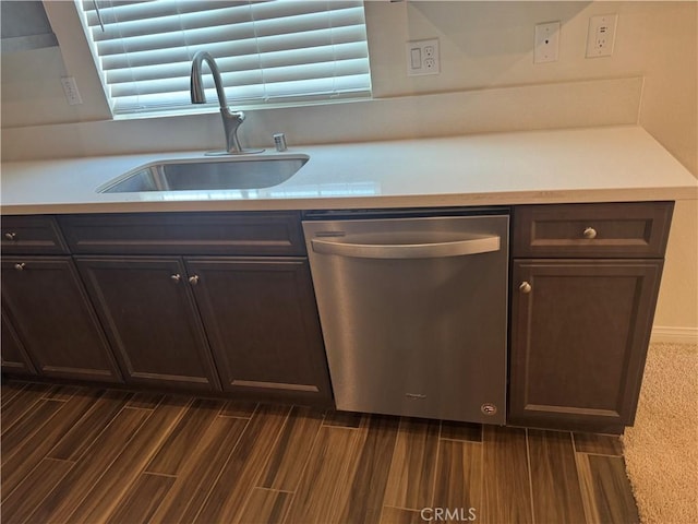 kitchen with dark brown cabinets, a sink, light countertops, dishwasher, and dark wood-style floors
