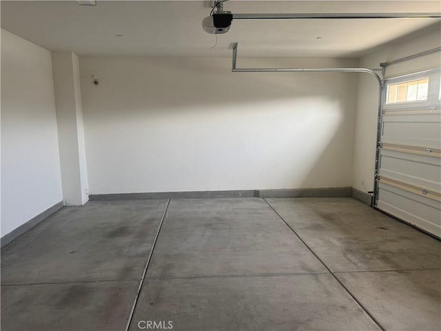garage featuring baseboards and a garage door opener