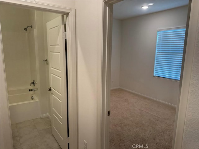 bathroom featuring baseboards and shower / tub combination