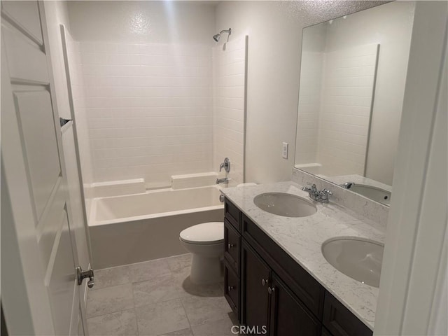 full bath featuring a sink, bathtub / shower combination, toilet, and a textured ceiling