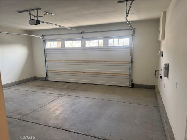garage featuring baseboards and a garage door opener