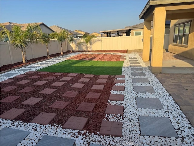 view of yard featuring a patio and a fenced backyard