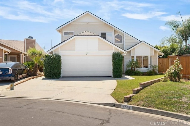 traditional-style house with fence, driveway, and a front yard