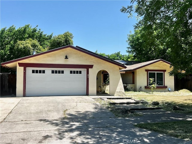 3324 Columbia Ave, Merced, CA 95340 - ranch-style home featuring concrete driveway, an attached garage, fence, and stucco siding