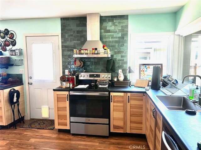 3324 Columbia Ave, Merced, CA 95340 - kitchen with wall chimney range hood, dark countertops, a sink, stainless steel appliances, and dark wood-type flooring