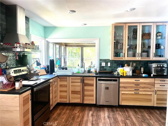 3324 Columbia Ave, Merced, CA 95340 - kitchen with wall chimney range hood, appliances with stainless steel finishes, dark countertops, a sink, and light brown cabinets