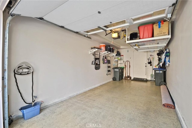 garage with baseboards and a garage door opener