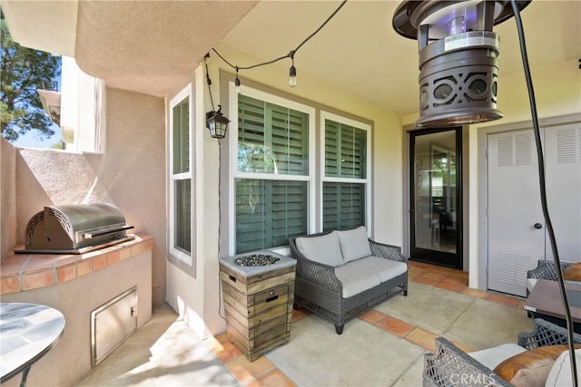 view of patio featuring area for grilling, an outdoor kitchen, and an outdoor hangout area