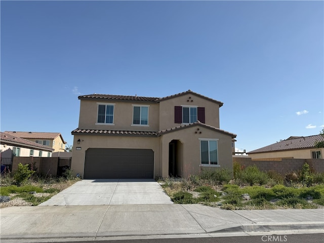 12327 Pinos Verde Ln, Victorville, CA 92392 - mediterranean / spanish home with stucco siding, a tiled roof, a garage, and concrete driveway