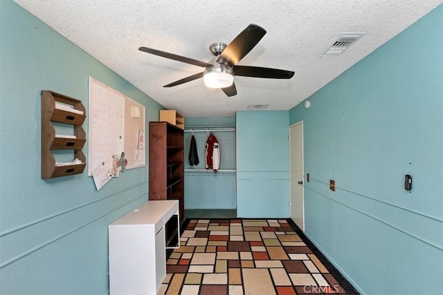 mudroom featuring a ceiling fan, a textured ceiling, and visible vents