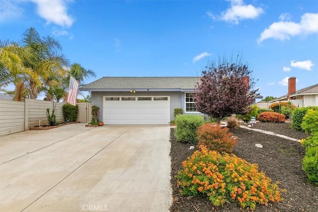 view of front of house with an attached garage, fence, driveway, and stucco siding
