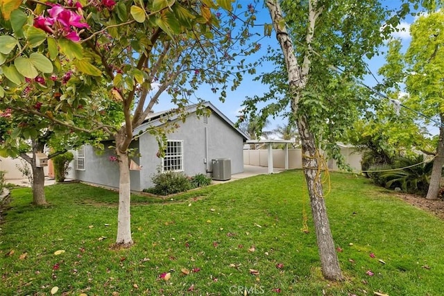 view of yard featuring fence, cooling unit, and a patio area