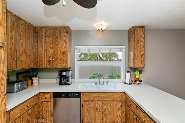 kitchen featuring a sink, dishwasher, brown cabinets, and light countertops