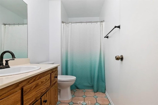 bathroom with toilet, tile patterned floors, curtained shower, and vanity