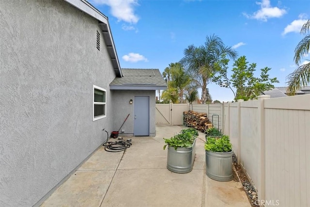view of patio featuring a fenced backyard and a gate